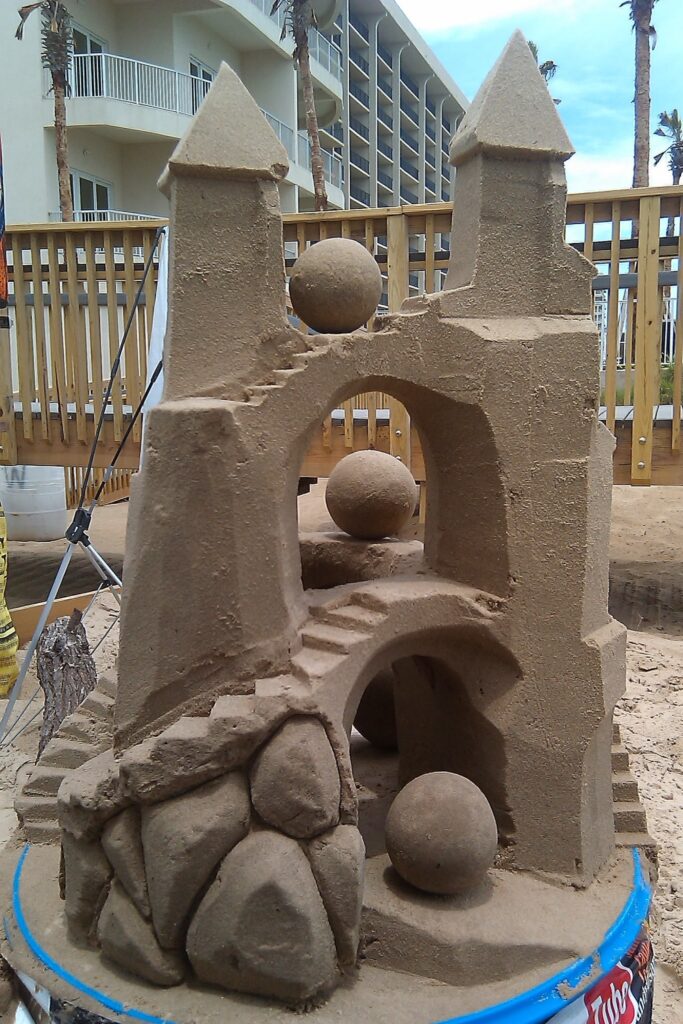 Picture shows a Twin Towered 4ft sandcastle with 2 bridges and many spheres all made using the science of sandcastles on south padre island by instructor andy hancock.