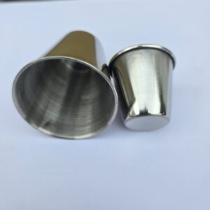 2 stainless steel shot cups that Andy Hancock uses to show how to make compacted small spheres for use as decoration during his luxury sandcastle lessons on south padre island